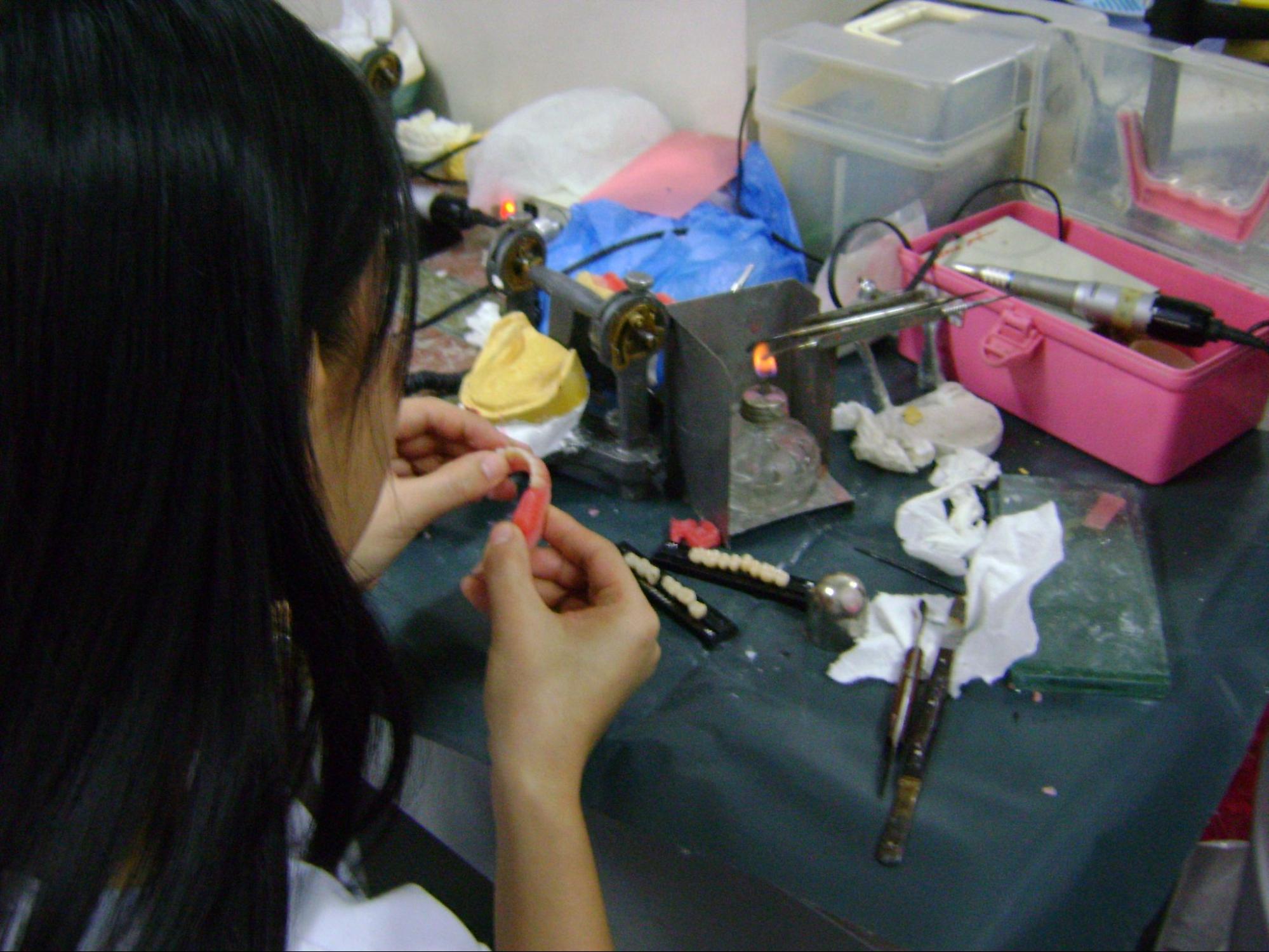 A denturist fabricating a set of dentures.