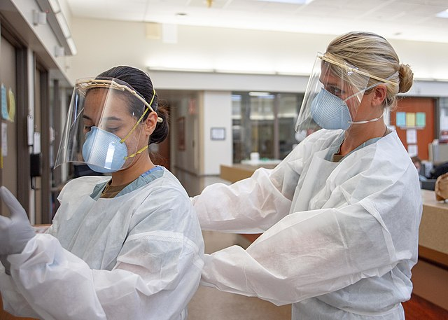 Medical personnel applying PPE