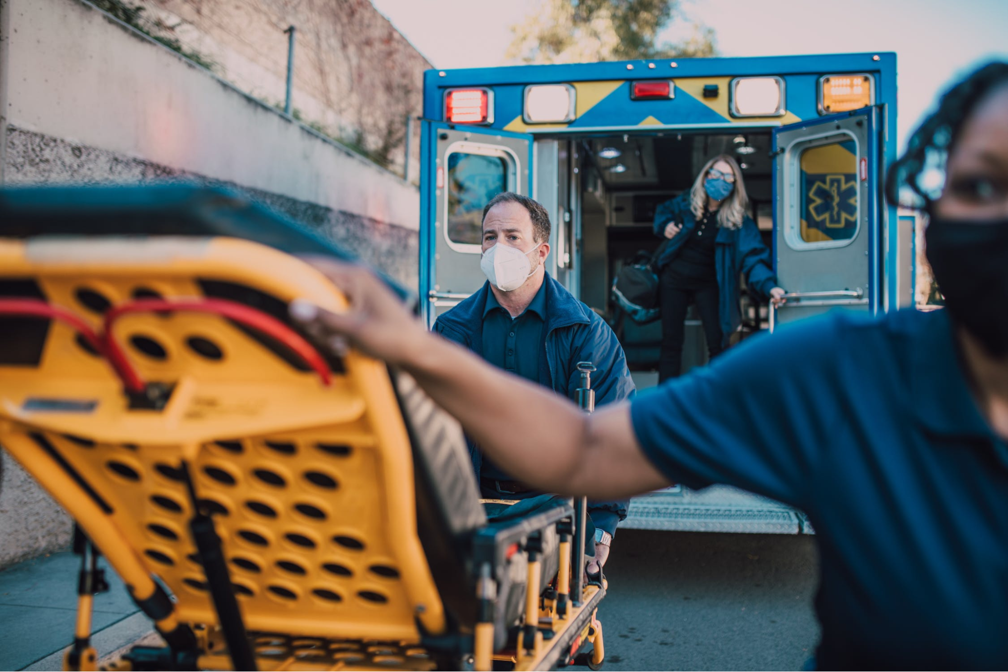 Medical professionals pushing a stretcher