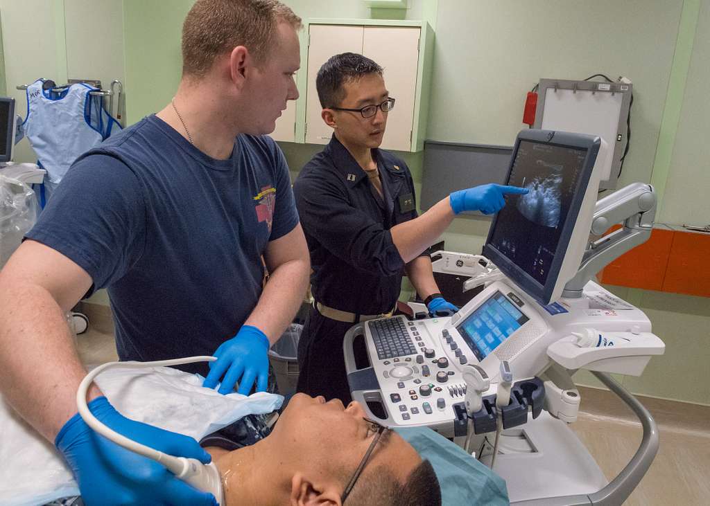 Healthcare providers performing a carotid ultrasound.