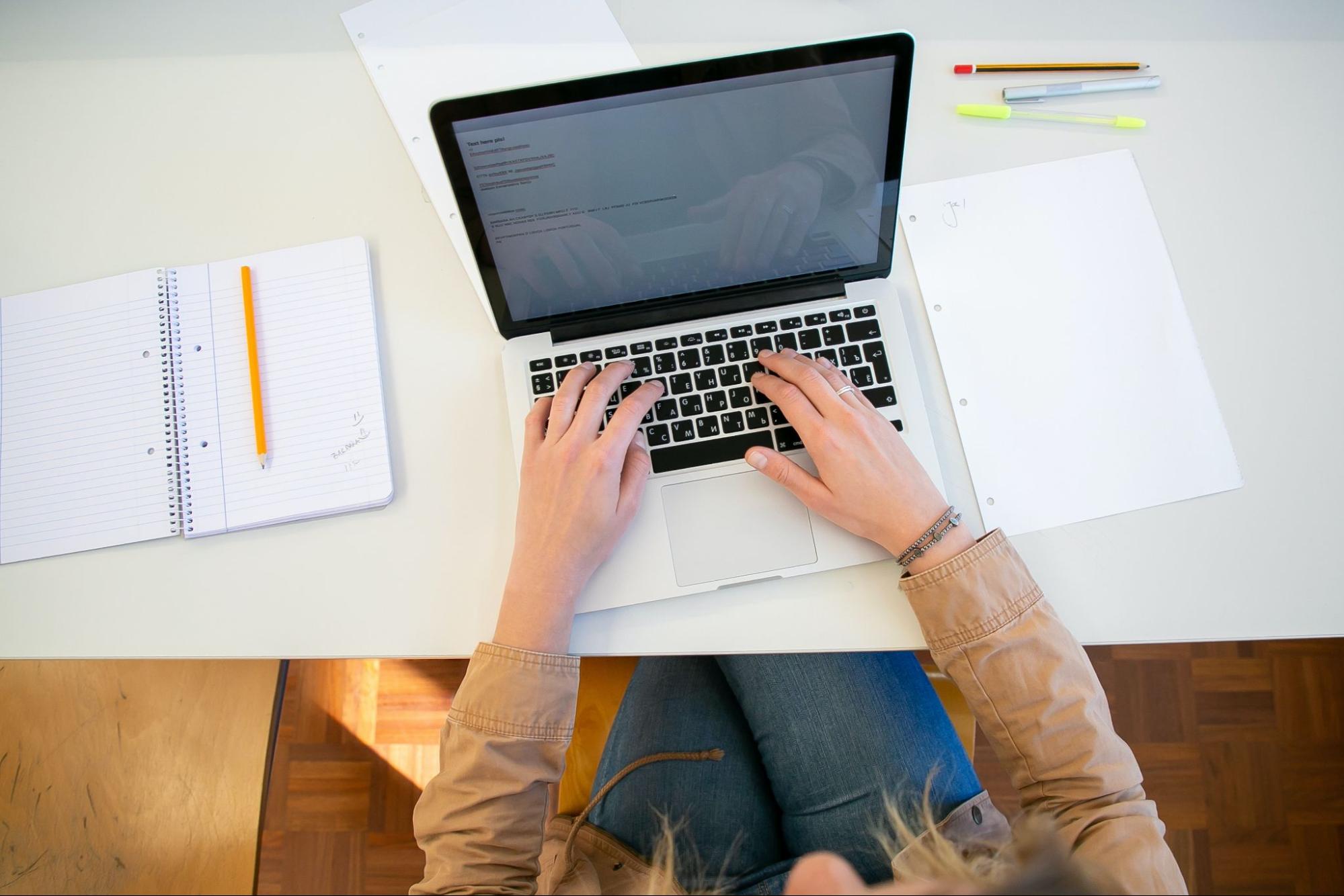 An individual is working on an assignment on their laptop computer.