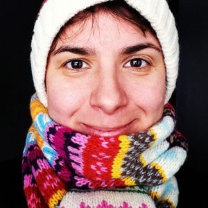 woman wearing a white hat and varicolored scarf