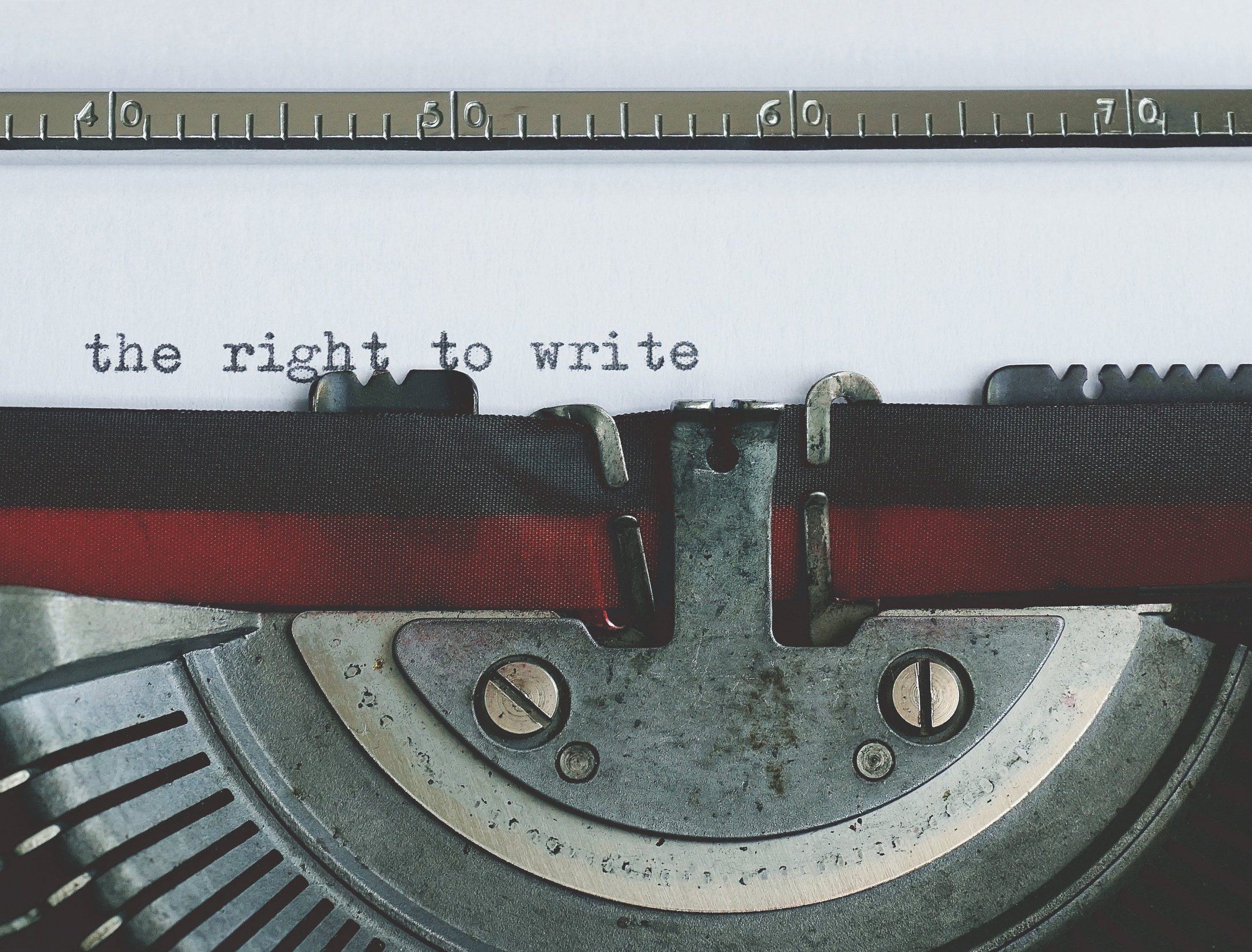 Close up of an old typewriter with the words "the right to write" visibly typed.