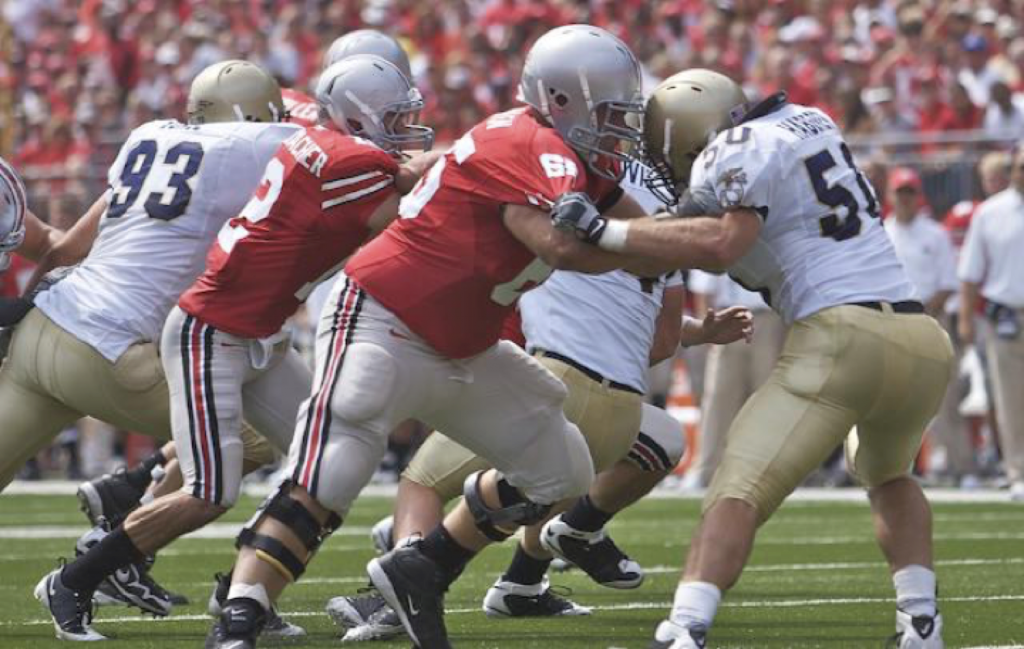 Buckeye football player Justin Boren blocking for Dane Sanzenbacher in a game against Navy in 2009