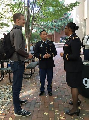 A U.S. Army Major (right) and Captain (center) answers questions from a medical student (left) about a career in Army medicine.