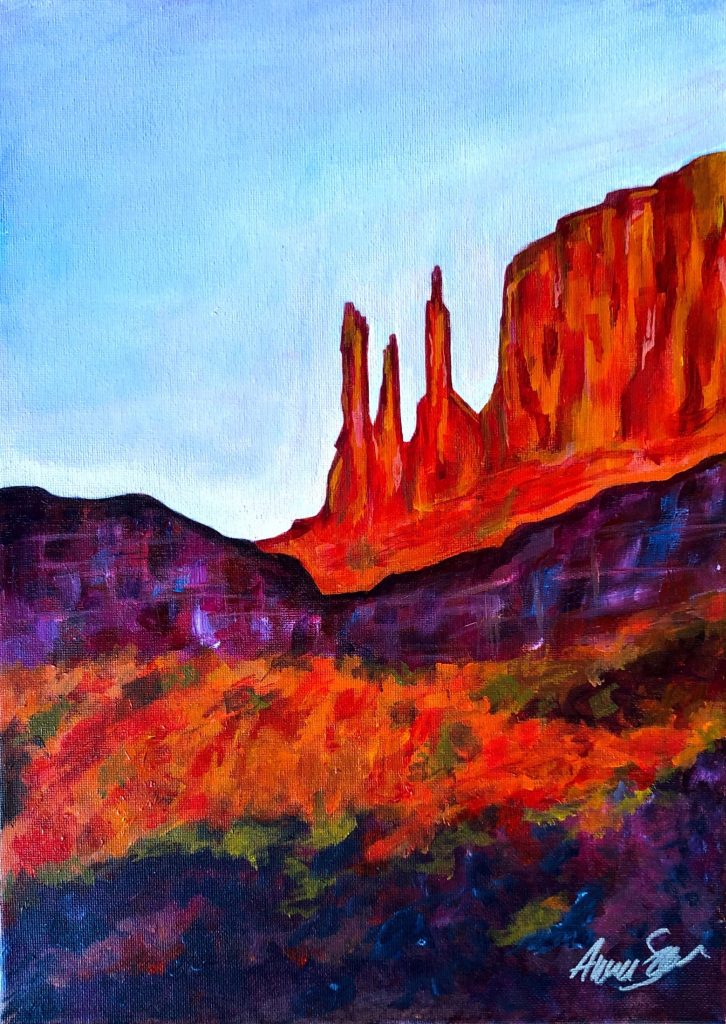 Purple and stylized foliage in the foreground rest upon orange and red rock. A line of lighter purple rock sits midway up the canvas, leading to orange and red spires of rock and a cliff face with a flat top disappearing to the right. The background is a light blue darkening slightly to the top left corner. Acrylic on canvas. The artist's signature is in the bottom left corner.