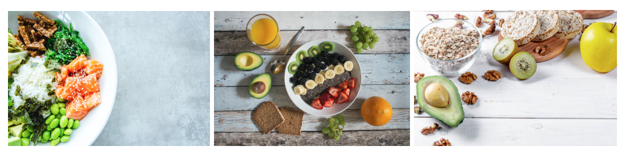 At left is a white bowl containing a variety of fresh meats, vegetables, and edamame. At center is a white bowl filled with a variety of fruit and seeds. At right is a glass bowl of grains with a variety of nuts and fruit around the bowl.