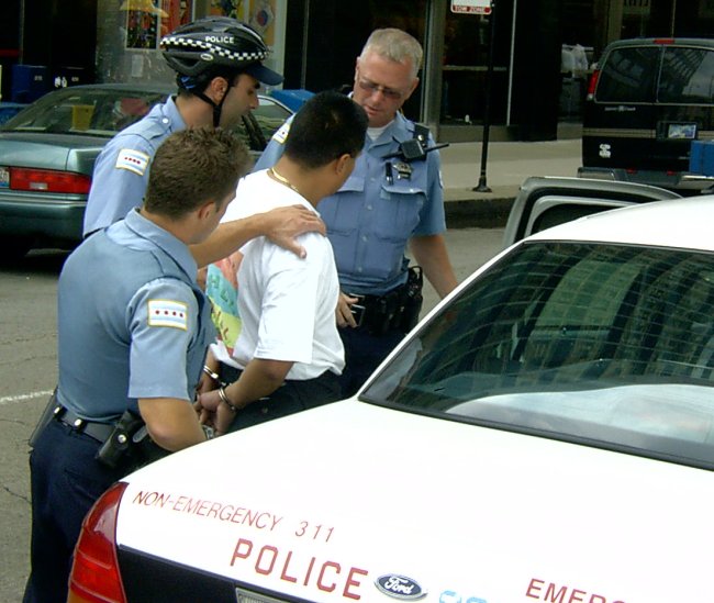 A latino man being arrested