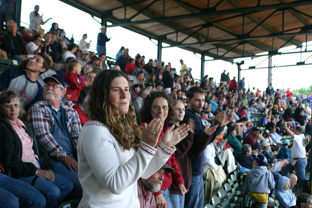 A crowd standing and cheering