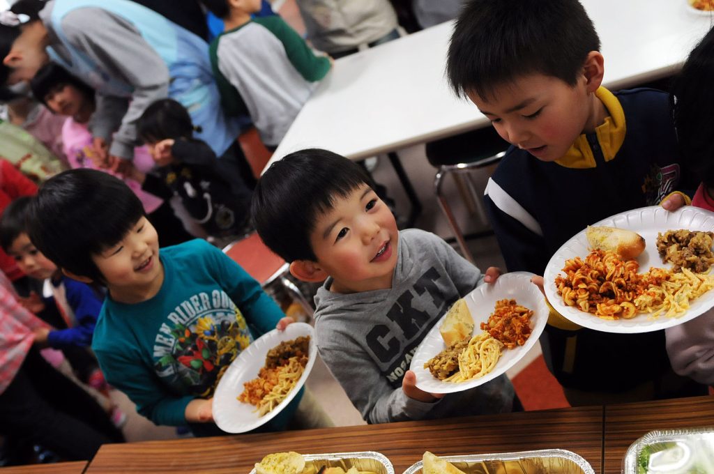 Smiling students in line for lunch