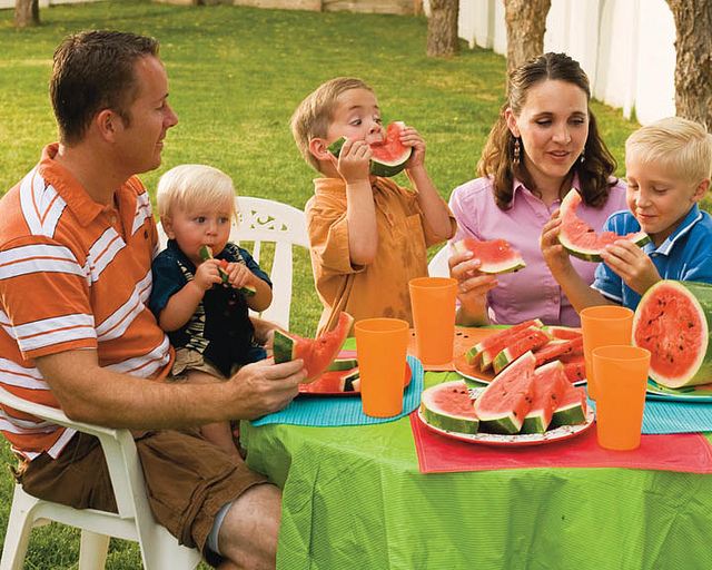 A gamily sharing some watermelon outside