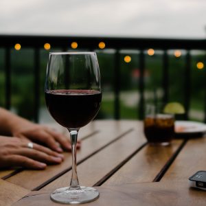 a glass of red wine on a table