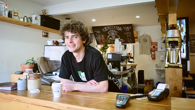 A happy barista behind a counter