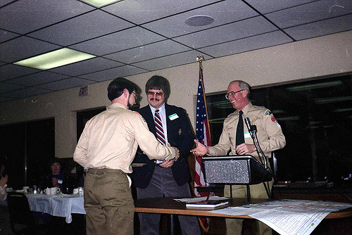 Scenic District Recognition Banquet 1985. Three men share greetings