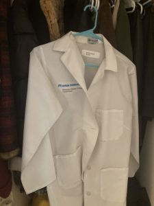 The author's lab coat hanging in a closet.