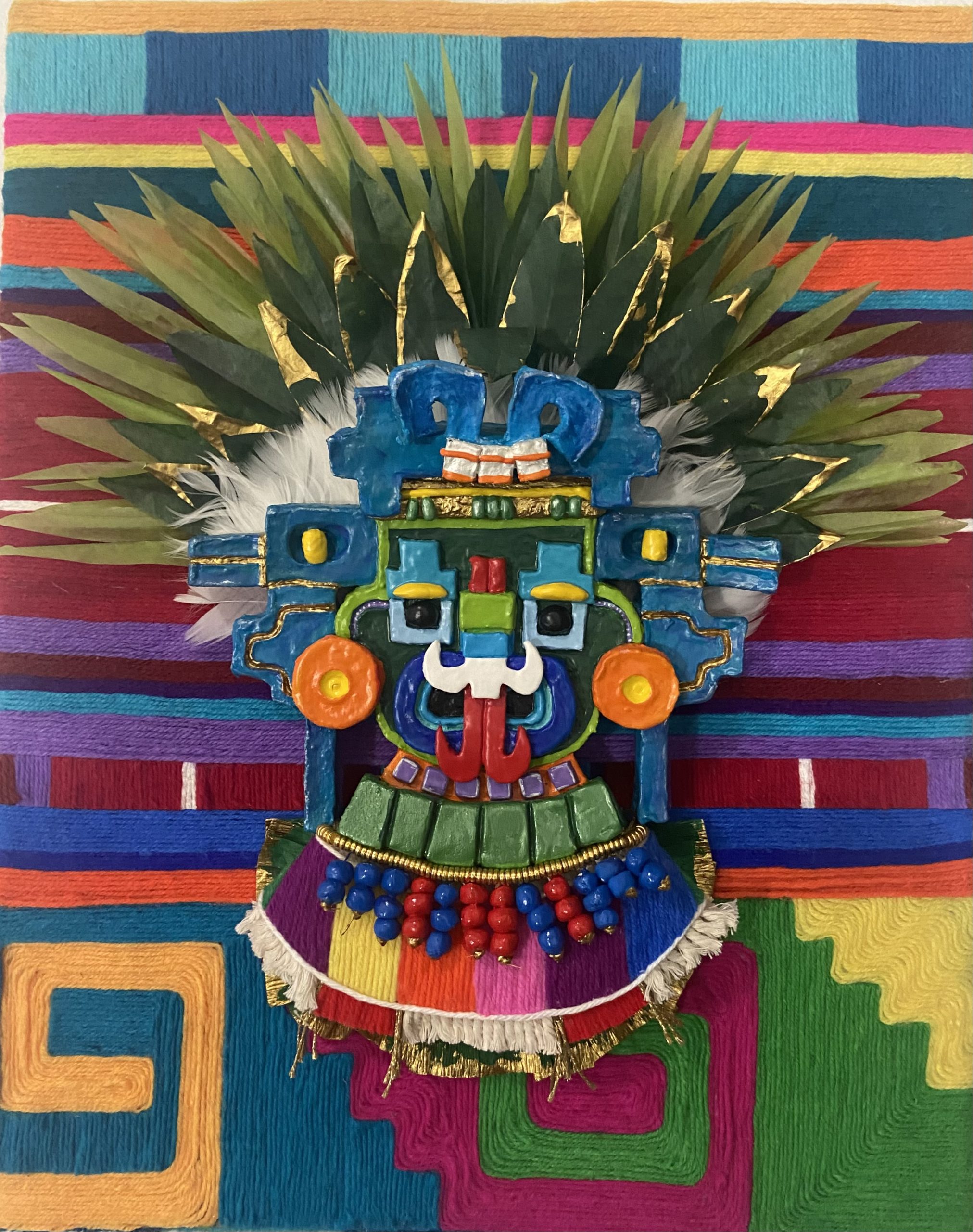 Mixed media artwork in geometric shapes of a face with earrings and a headdress made of leaves, and a background made of yarn