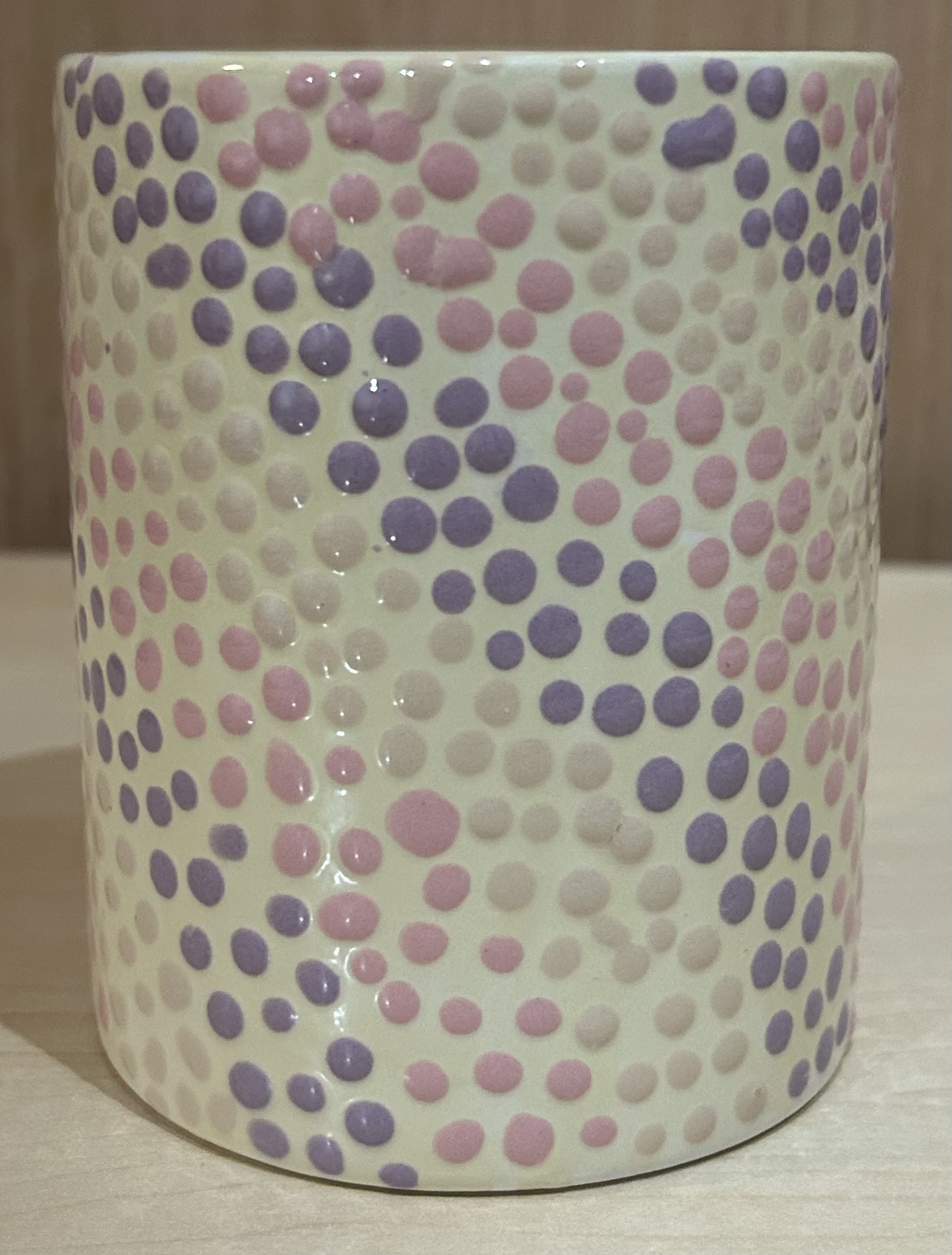 Ceramic mug with purple, pink, and cream dots - front view