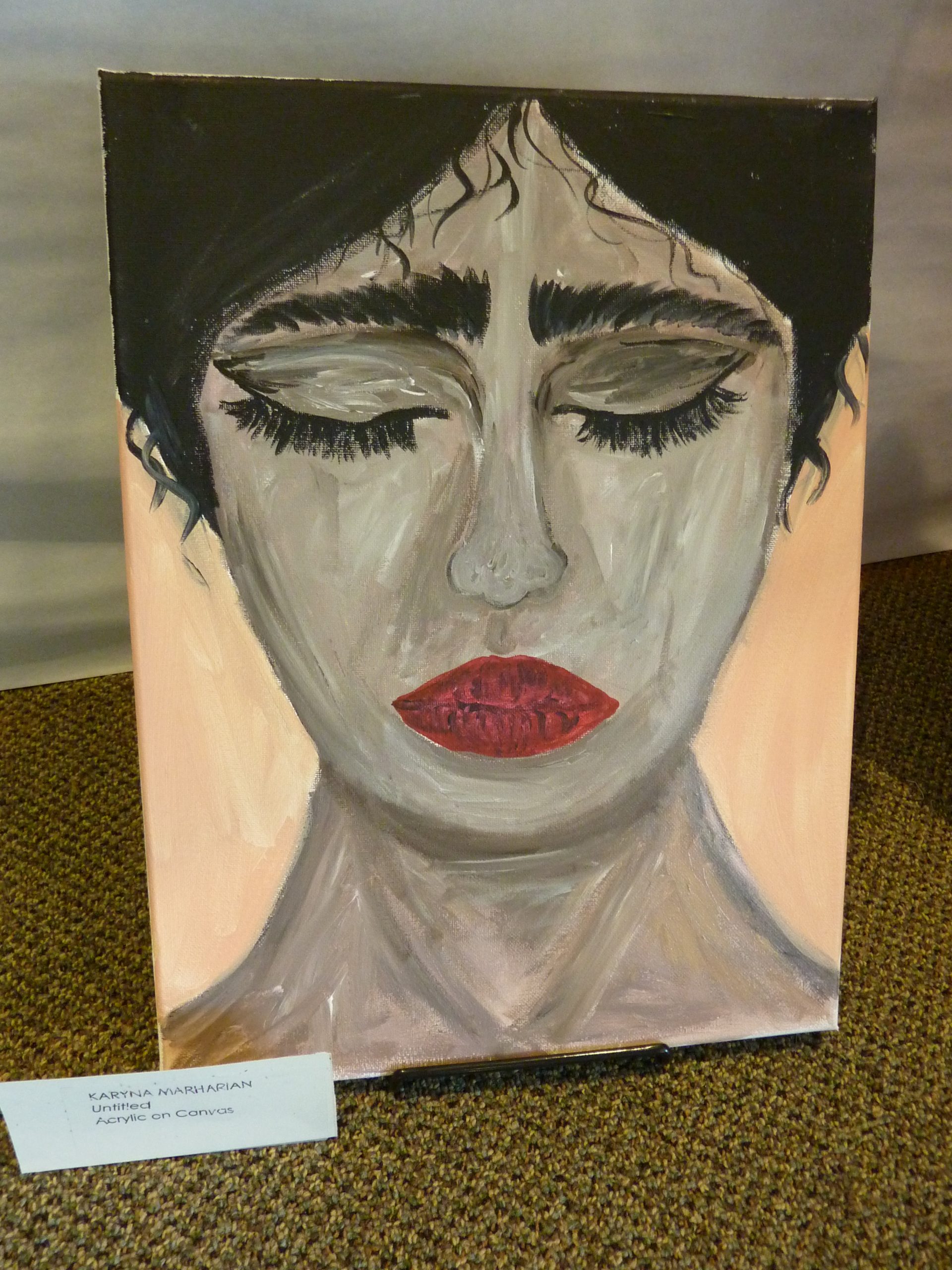 Painting of a sad face with eyes closed looking down, with black hair and red lips