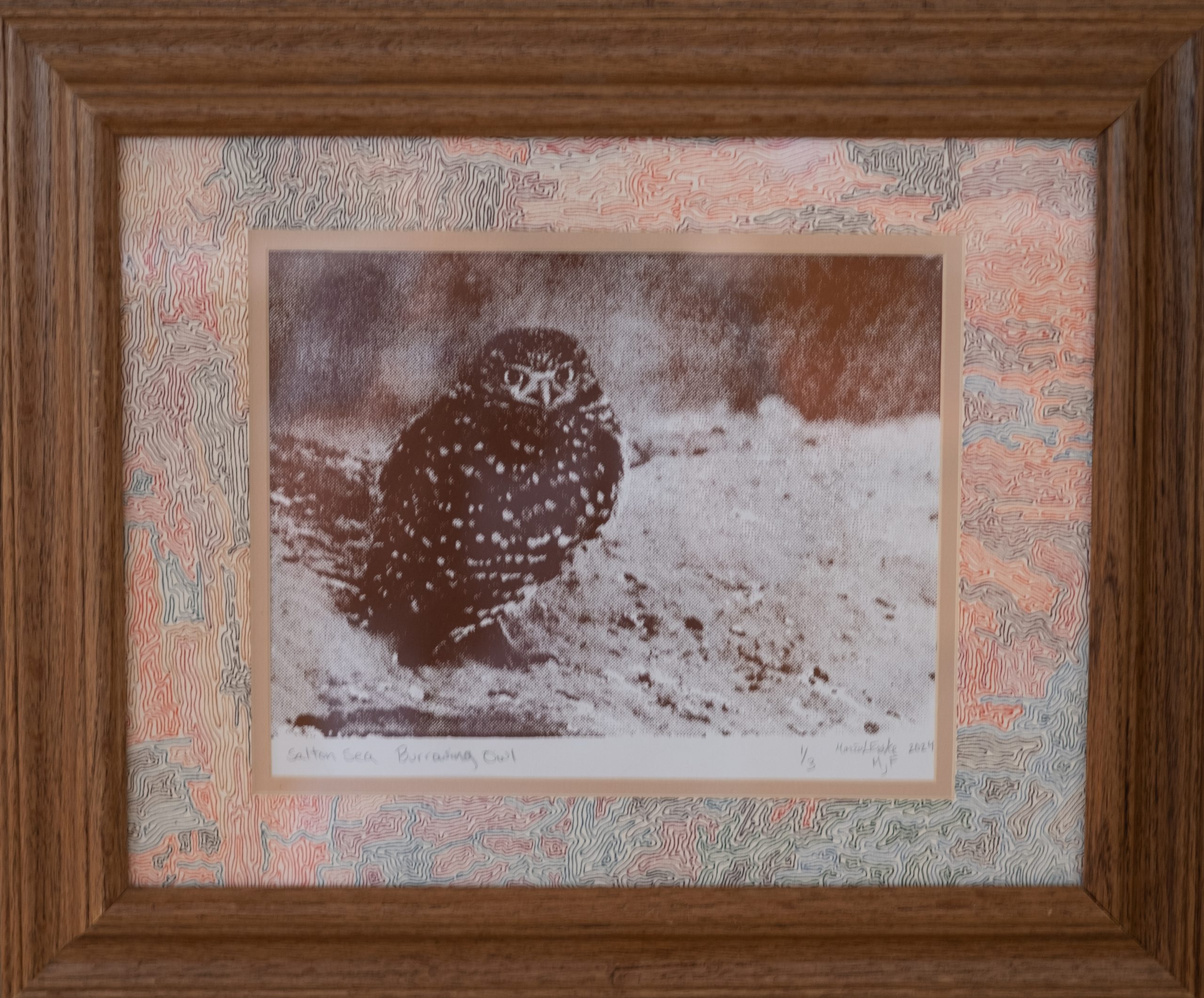 Screen print ink owl with puffed chest feathers standing in snow