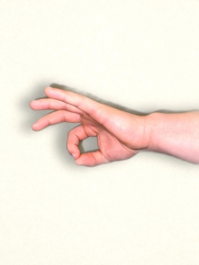 Photo showing a hand with thumb and index finger touching