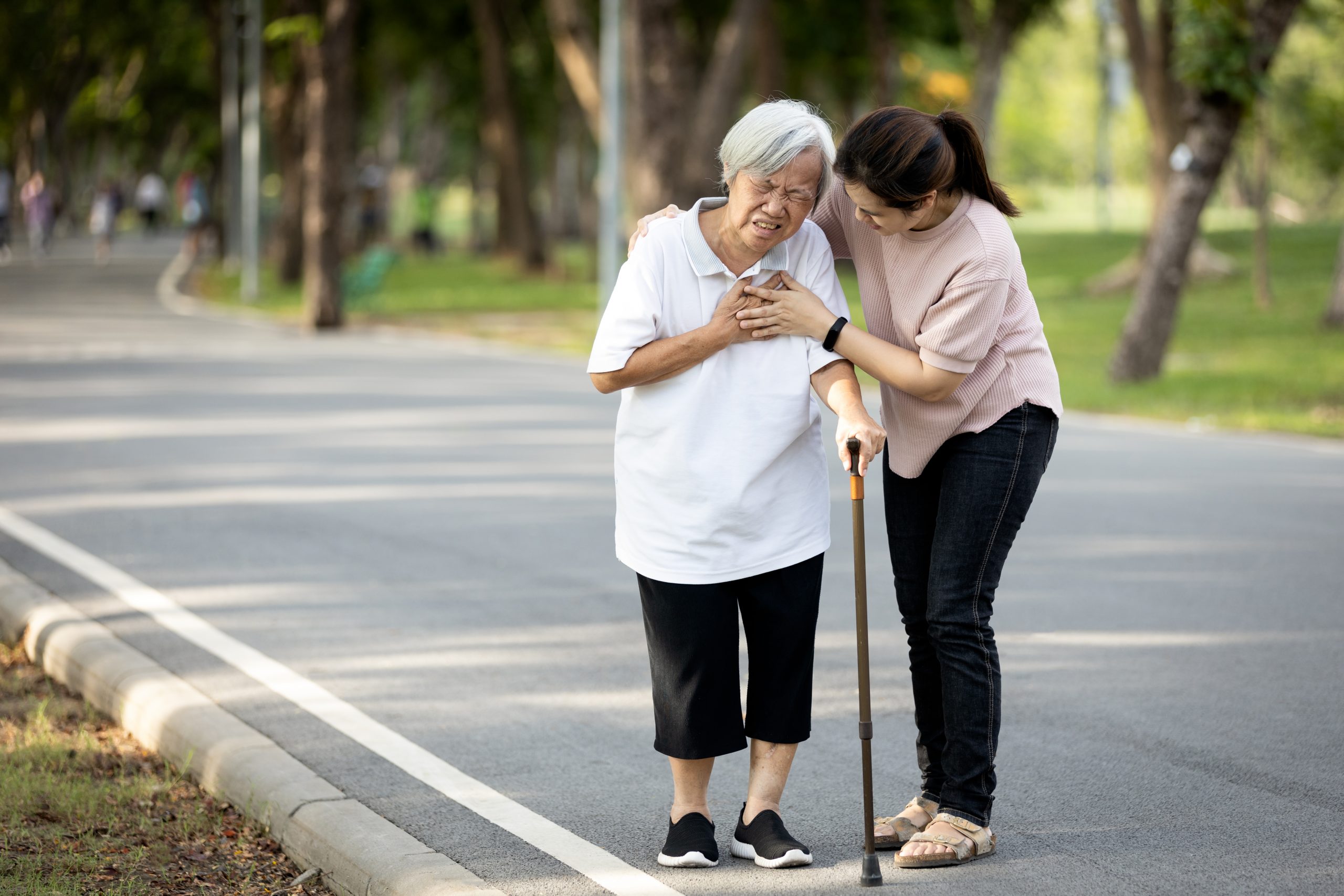 Image of elderly woman in distress, while walking with caregiver