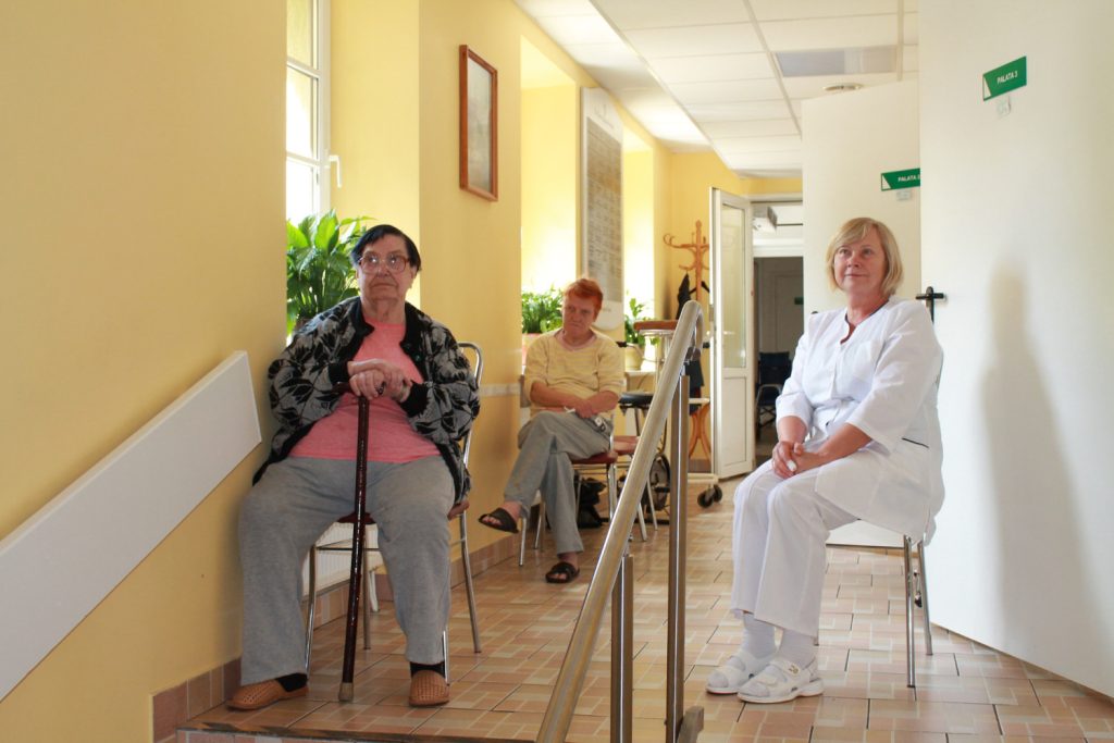 Image showing elderly three older women sitting in a hallway, facing camera