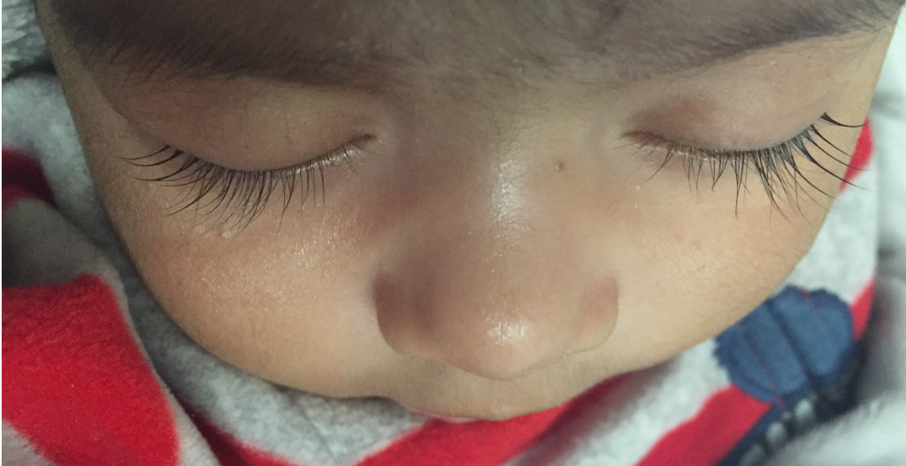 Image showing closeup of young child's eyelashes.