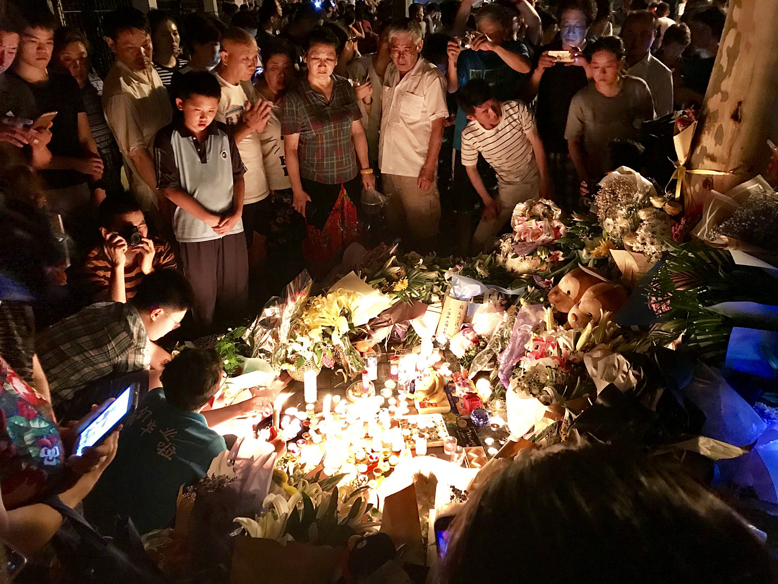 Image showing a Community Grieving at a candlelight vigil