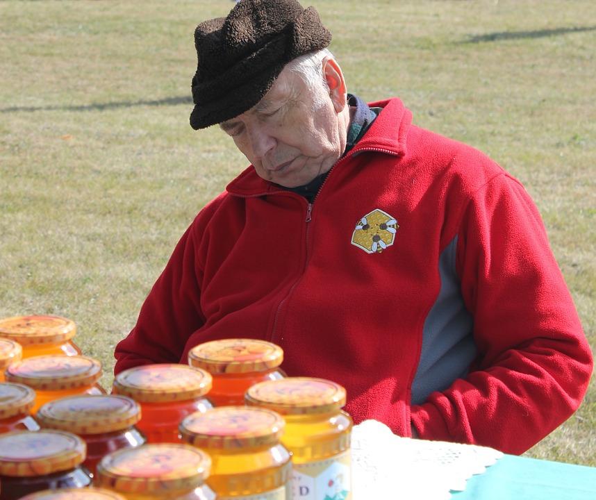 Image of older man sleeping at an outdoor table setting