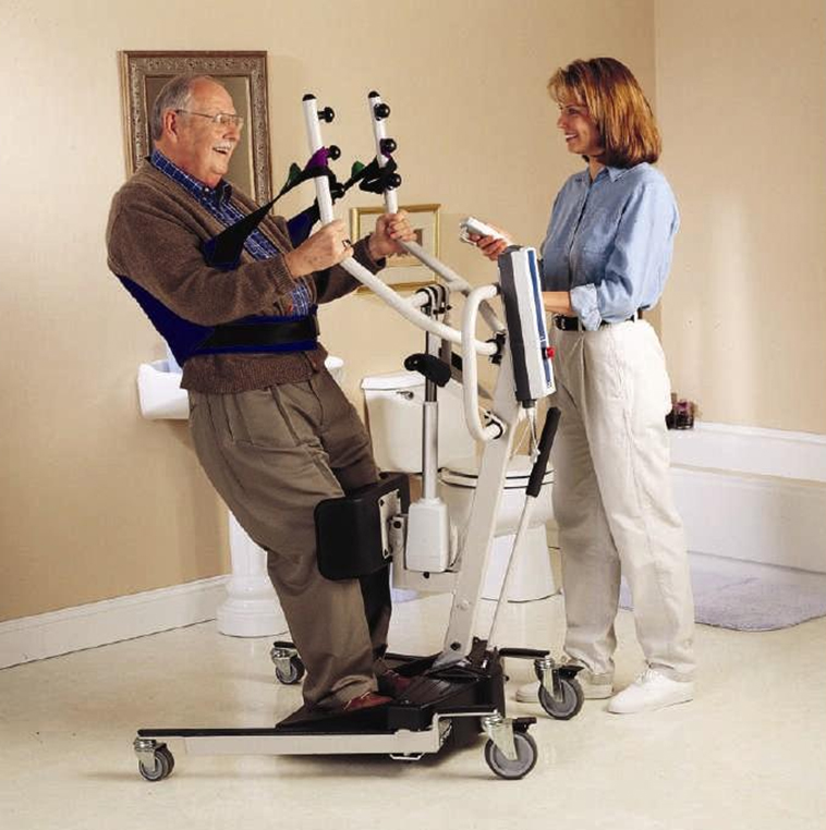 Image showing a simulated patient and caretaker using an electric sit to stand lift