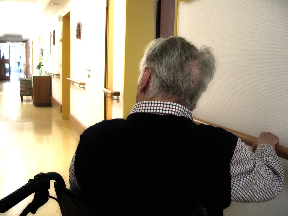 Image showing elderly man in wheelchair looking down a hallway