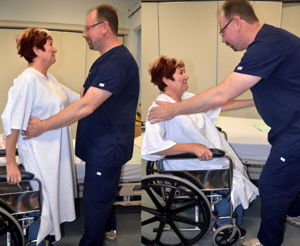 Image of a nurse Assisting a simulated Patient to a Wheelchair