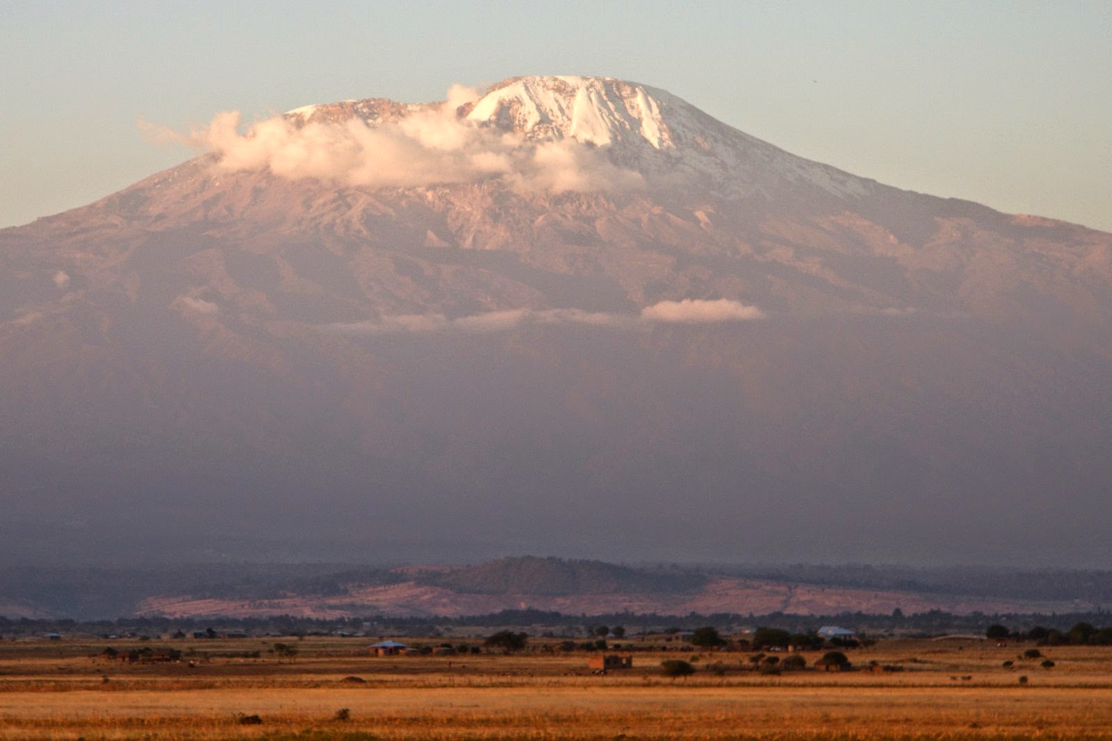 Sunset on Kilimanjaro. At 19,341 feet high and with more than 10,000 feet of local relief, the slopes of Kilimanjaro make a powerful demonstration of the effects of altitude on temperature. The lower plains have tropical warmth while the summit is covered in snow and ice year-round. 2012 photo by Tim Scharks.