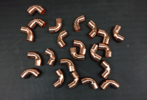 22 copper fittings on a table