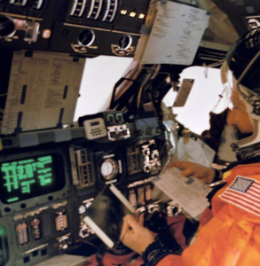 Astronauts learning about the shuttle controls.