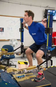 An astronaut exercising.