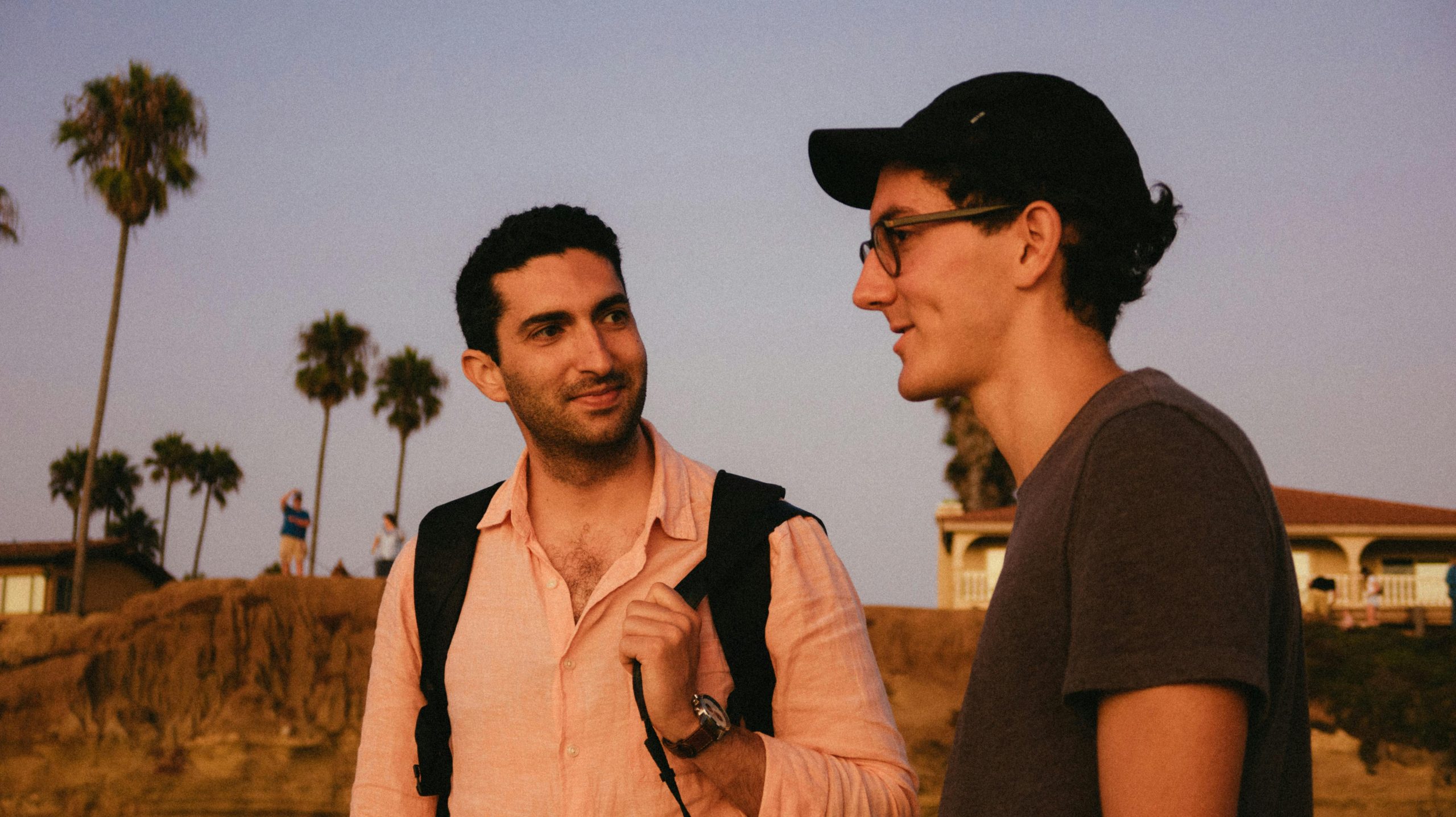 two men talking to each other outside