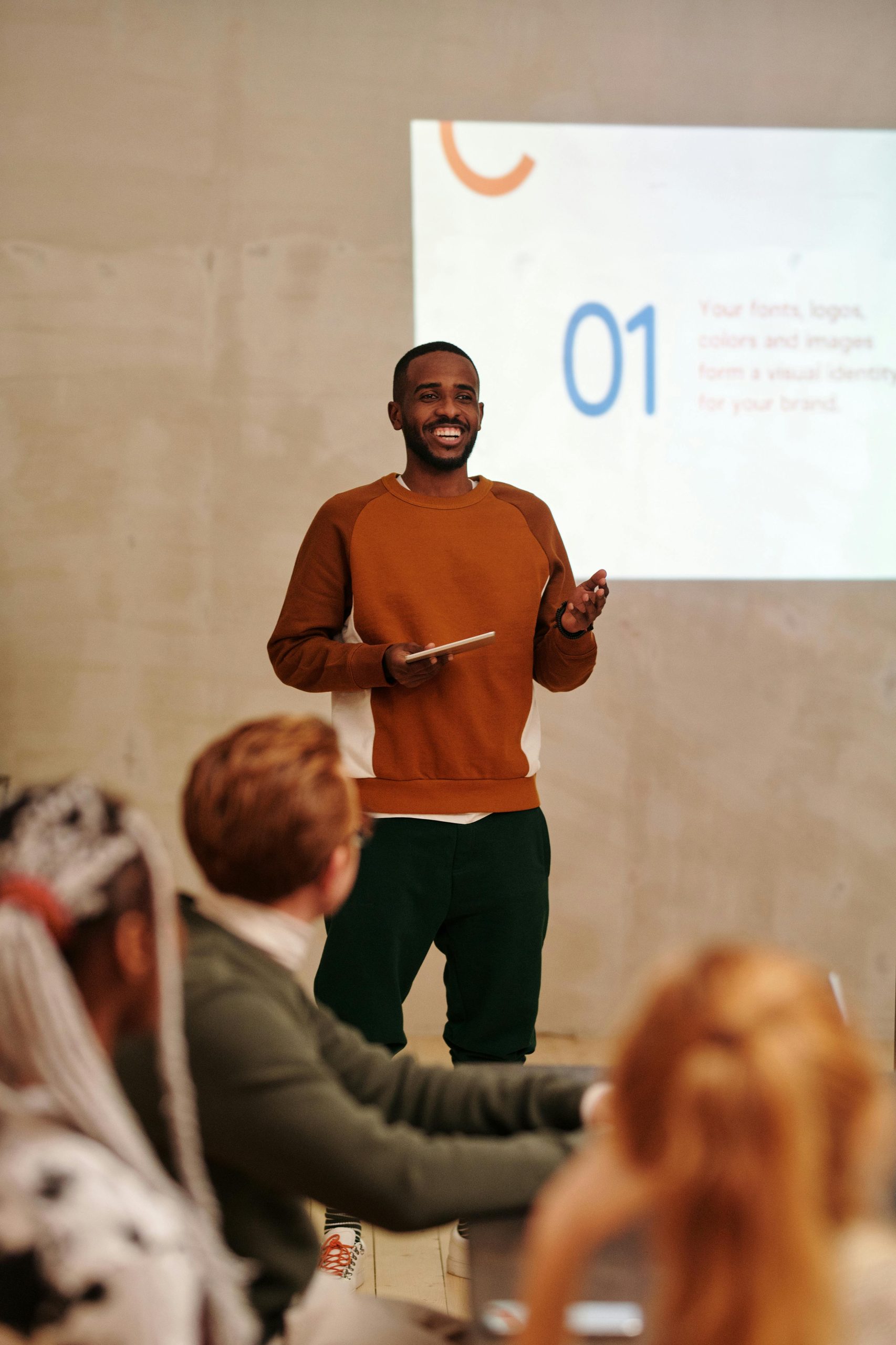 photo of a man giving a presentation in front of an audience