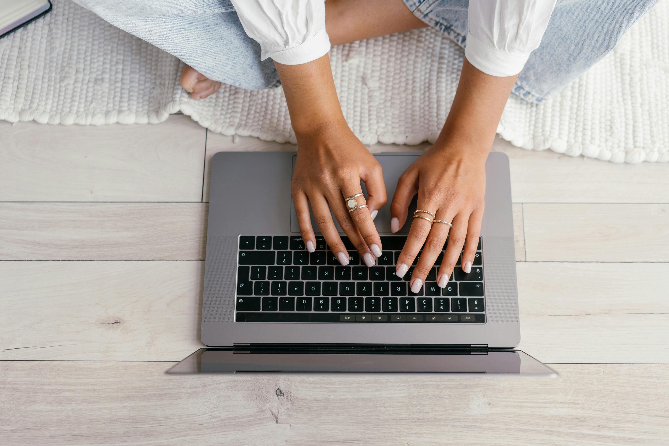 photo of a woman typing on a laptop