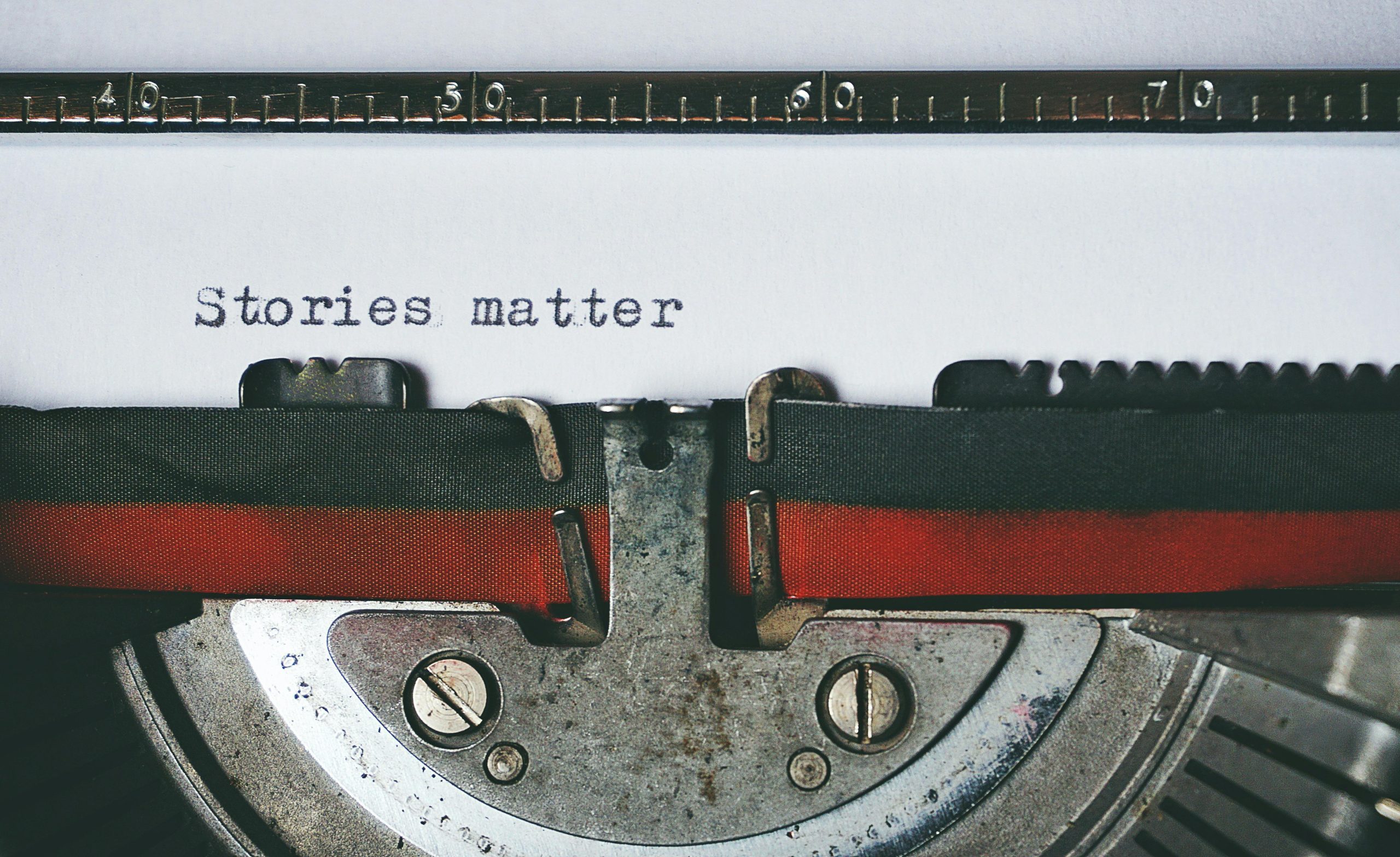 photo of a typewriter with the words "stories matter"