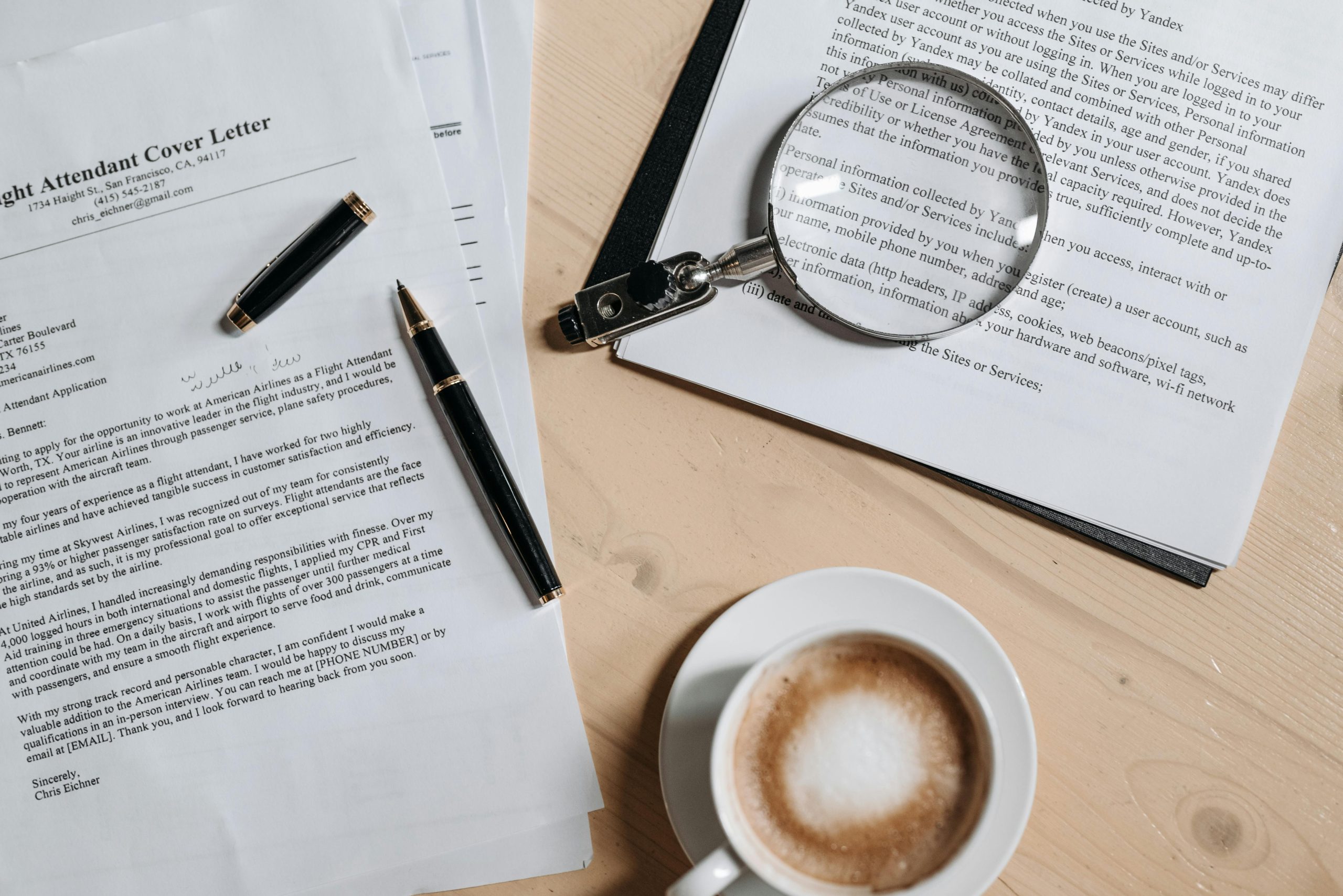 photo of an example cover letter on a desk with a pen and coffee cup